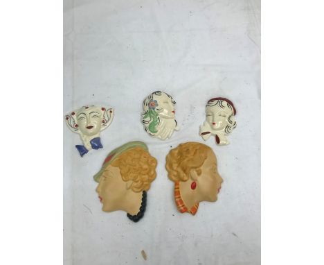 Three modern Clarice Cliff face masks; together with two others