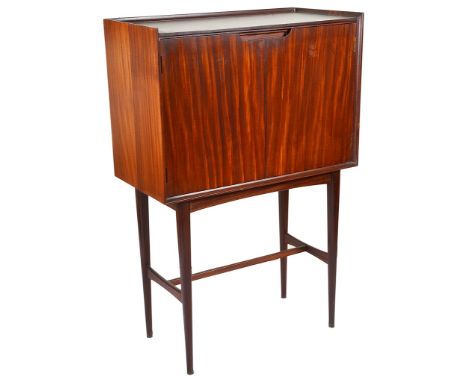 A Drinks Cabinet:Circa 1960s, rosewood & rosewood veneer, opening to reveal a fitted shelf, supported on a four legged rosewo