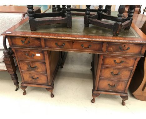 A mahogany twin pedastal leather-topped desk