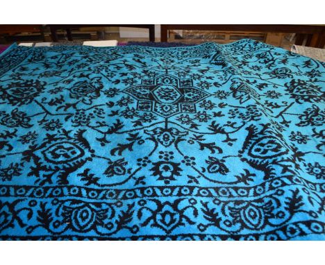 LARGE RUG WITH GEOMETRIC DESIGN ON BLUE/GREEN GROUND (Please note VAT is to be added on hammer price for this lot)