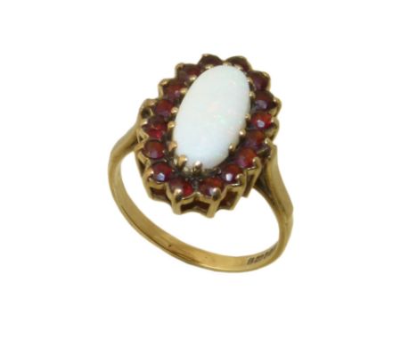 A 9ct gold opal and garnet cluster ring, the oval opal cabochon within a circular shape garnet surround, Condition reports ar