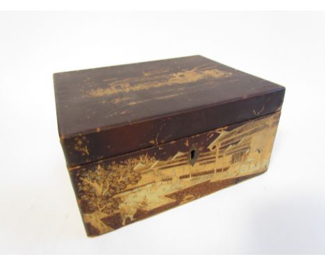 A late 19th Century Oriental lacquered tea caddy with pewter lining