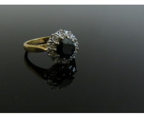 An 18ct gold sapphire and diamond cluster ring. Size J/K, 4.4g