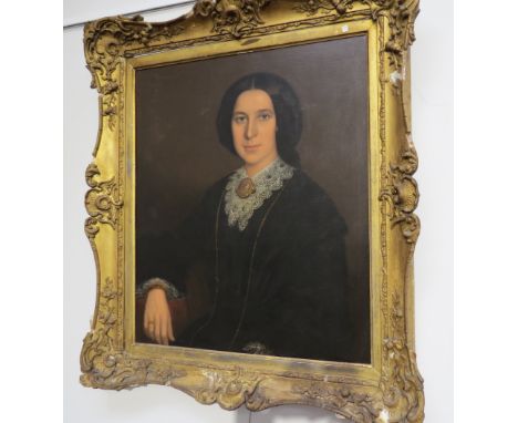 A 19th Century oil portrait of female with black hair pendant and lace collar details verso stating Rebecca Hoskin (nee M Bro