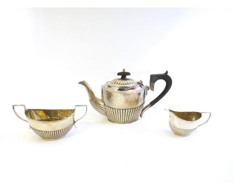 A matched silver three-piece bachelor's tea set consisting of teapot, sucrier and milk jug, fluted design, the teapot by Robi