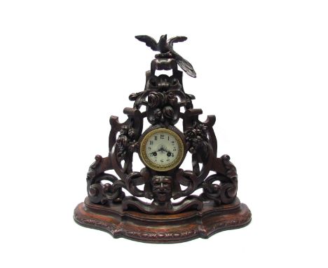 A large Black Forest style carved mantel clock, French movement by Japy Freres Circa 1890, striking on a bell. With pendulum 