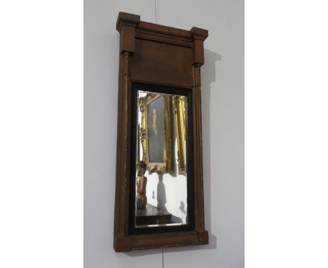 A Regency gilt gesso wall mirror with architectural break front top over column detail sides, ebonised inner frame, bevelled 