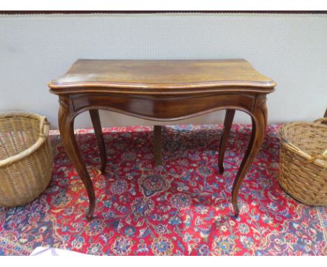 A 19th Century French Hepplewhite style rosewood card table, the lift top over serpentine front on cabriole legs to scroll fe