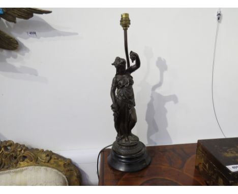 A figural bronzed spelter table lamp in the form of a female with grapes