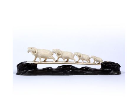 Ivory carving of a bridge Japanese, late Meiji depicting a line of four long horned goats, signed on red seal, on wood stand 