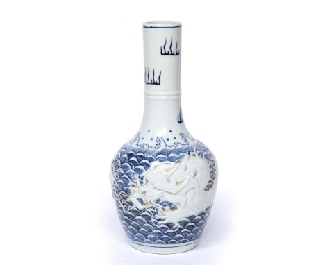 Blue and white bottle vase Chinese, with raised dragon and flaming pearl on a blue wave ground, seal mark to the base, mark r