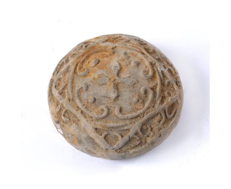 Pottery scroll weight Chinese, Han Dynasty with star and ruyi design to one side, the reverse with shi-lin dragon 10cm across