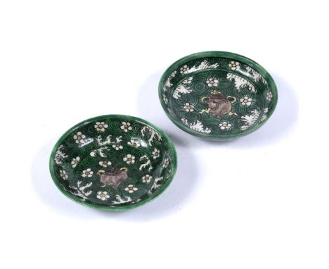 Near pair of famille verte saucer dishes Chinese, Kangxi (1662-1722) decorated in underglaze green, decorated with a central 