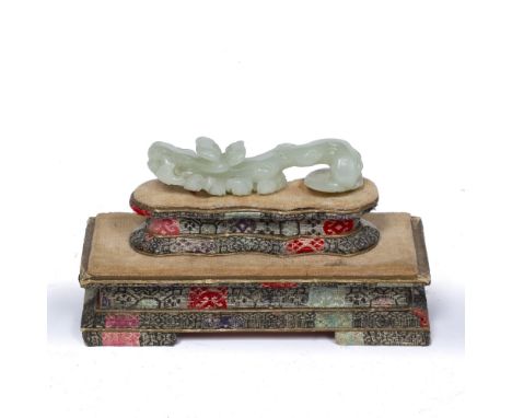 White jade belt hook Chinese, 18th/19th Century naturalistically shaped with lingzhi, on a later fabric base 8cm across