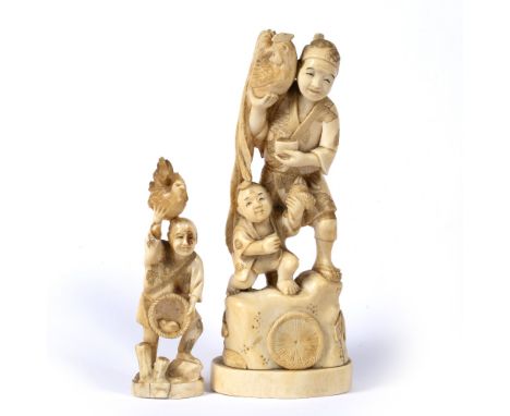 Ivory okimono Japanese of standing figure holding cockerel in his right hand and with crouching boy beneath 18.5cm and one ot