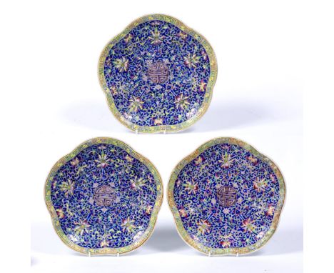 Three polychrome medallion shaped stands Chinese late 19th/early 20th Century of blue ground with Indian lotus scroll and Gre