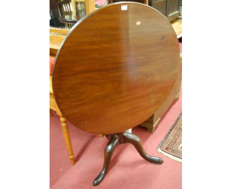A George III mahogany circular tilt-top tripod table, raised on hipped supports 