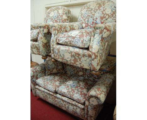 An Edwardian floral upholstered two-seater sofa; together with a pair of matching upholstered armchairs (3) 