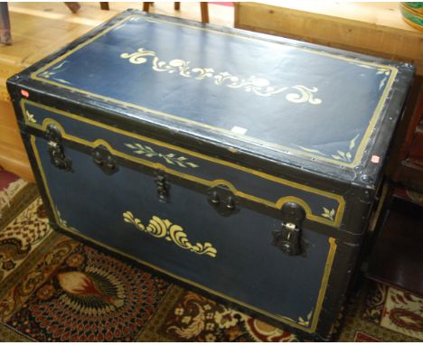 A painted canvas and metal bound hinge-top travelling trunk 
