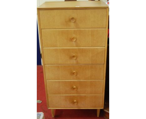 A 1950s light oak squarefront chest of six drawers, having integral turned handles, on further turned supports, h.123.5cm, w.