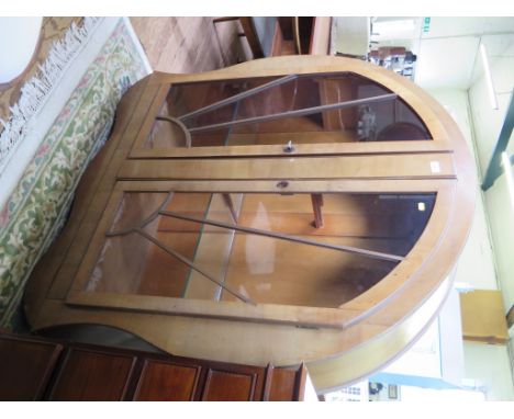 An Art Deco walnut display cabinet of arched sunburst form with twin glazed doors 121cm wide