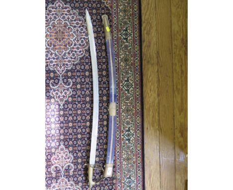 An Indian brass hilted sword, with velvet scabbard, length of blade 79cm long