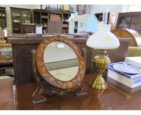 A Dutch inlaid oval table mirror 37.5cm high, and a brass oil lamp