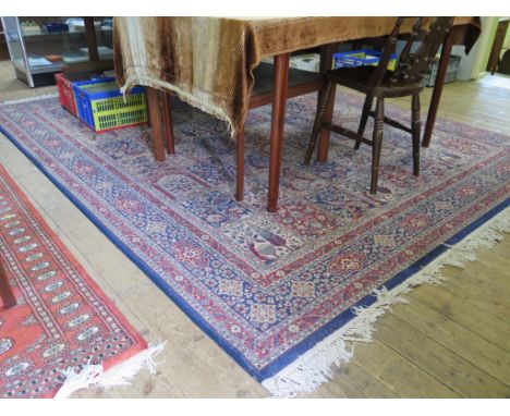 An Indian Tree of Life carpet with eight rows of eight panels within a multiple border, 316cm x 241cm