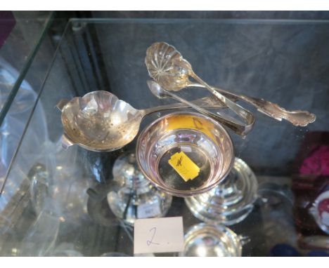 A collection of silver items to include a tea strainer and sifter spoon, a small silver dish, etc