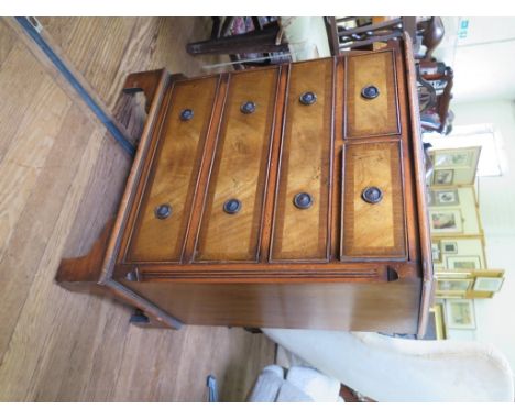 A reproduction crossbanded mahogany chest of drawers with two short and three long drawers, on bracket feet, 61cm wide