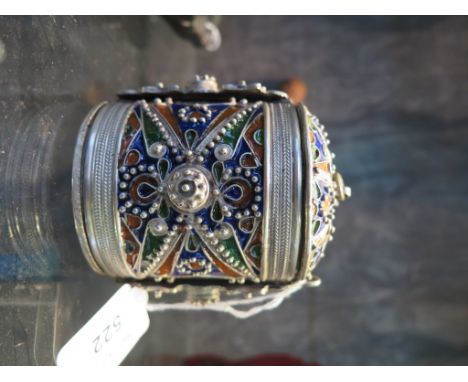 An Eastern white metal and enamel cylindrical box, with detachable lid and base, and hinged sides held by a pin 9.5cm high