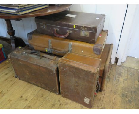 A canvas and wood cabin trunk, and four various suitcases