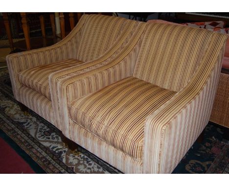 A pair of contemporary corderoy striped upholstered armchairs, each with cushion seats, raised on tapering square supports to