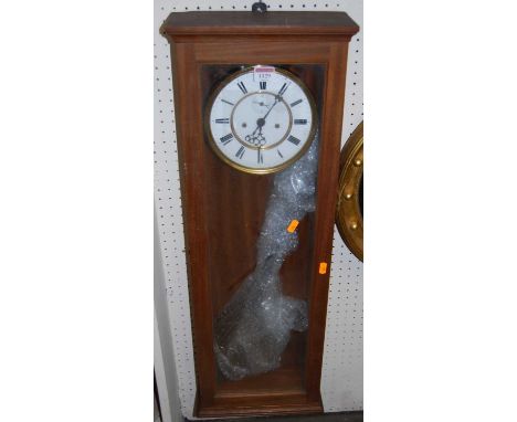 An early 20th century walnut drop trunk wall clock, with white enamelled dial, twin winding holes, and pendulum