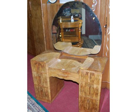 An Art Deco figured walnut kneehole mirror back dressing table, width 104cm