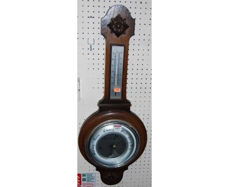 A 1930s oak aneroid two dial wheel barometer