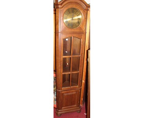 A contemporary Belgian oak freestanding corner clock having glazed trunk door, height 207cm