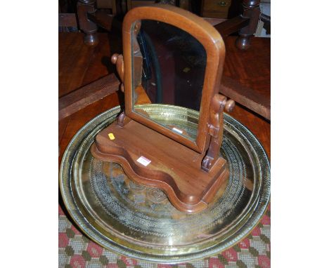 Two Eastern engraved circular brass trays; together with a Victorian mahogany swing toilet mirror (3)
