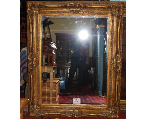 A large contemporary floral gilt framed bevelled rectangular wall mirror, 160 x 129cm