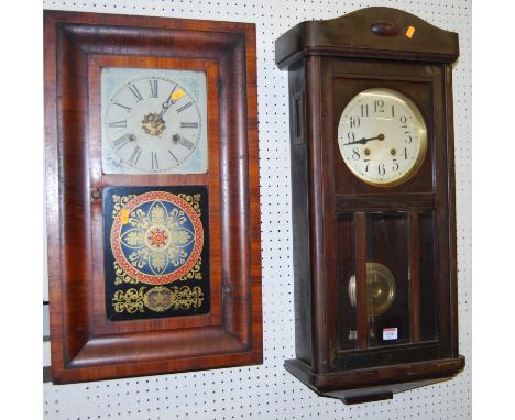 An early 20th century walnut drop trunk wall clock, with pendulum, together with an early 20th century American mahogany and 