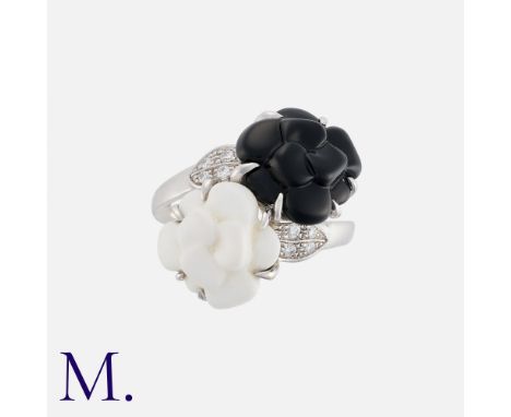 CHANEL, A Camellia Ring in 18k white gold, comprising black and white ceramic camellia flowers in crossover design, accented 