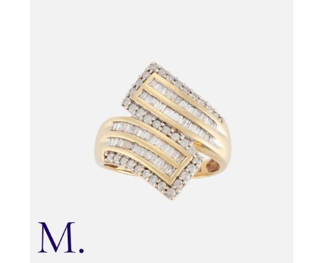A Diamond Cross-Over Ring in 9K gold, set with round and baguette-cut diamonds in a cross-over design.  Hallmarked for 9ct go