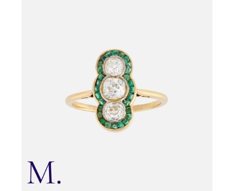 An Emerald and Diamond Ring in 18K yellow gold, set with three old cut diamonds weighing approx. 1.0ct in total, with calibra