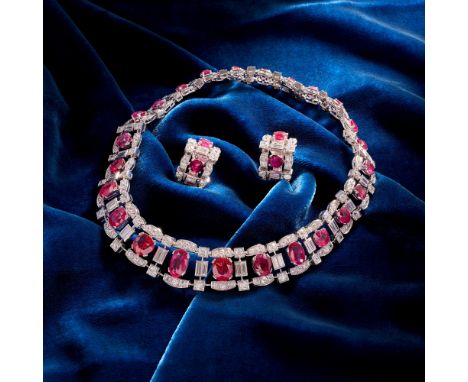 An Important Burma Ruby and Diamond Collar and Earrings Set in 18K white gold.  The collar is set with 24 oval and cushion cu