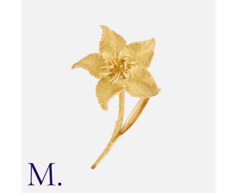 HERMES. A Flower Brooch in 18K yellow gold, with five-petal textured flower.  Signed Hermes Paris and serial numbered.  Frenc