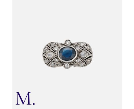 NO RESERVE. A Sapphire and Diamond Ring set in the centre of a plaque with an oval cut sapphire measuring approx. 6x5mmSize: 