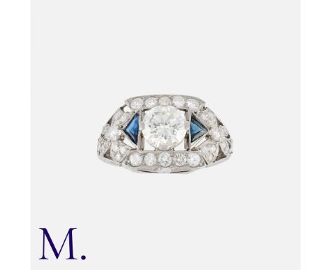 An Art Deco Sapphire and Diamond Ring in platinum, set centrally with a diamond weighing 1.35ct., with calibrated sapphires a