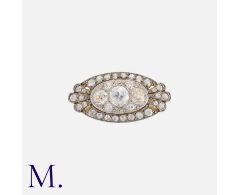 An Antique Diamond Ring in yellow gold and silver, set with three principal old cut diamonds, weighing approximately 1.0ct in