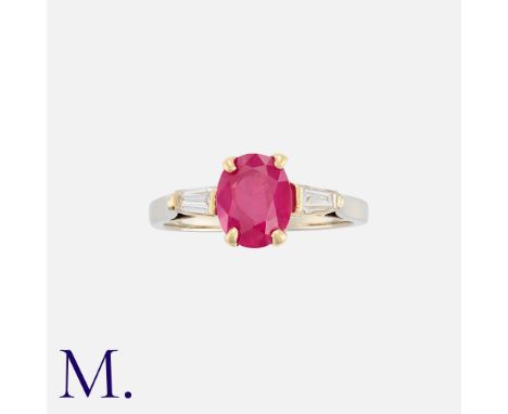 A French Burma No Heat Ruby And Diamond Ring in platinum and 18k yellow gold, set with a principal oval cut Burmese ruby of 1