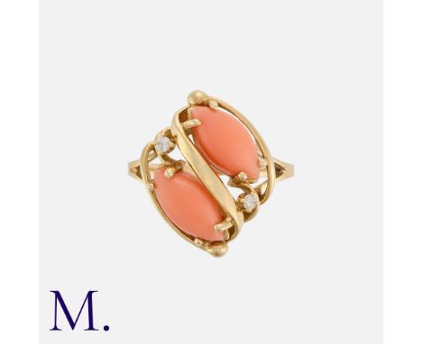 A Coral and Diamond Ring in 14k yellow gold, set with two coral cabochons and two round accent diamonds in a twist pattern.Si
